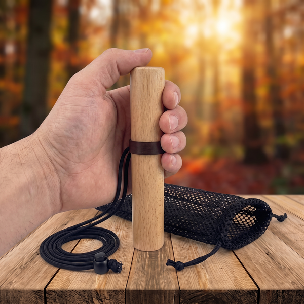 Hand holding the beech wood deer grunt call, showing its size